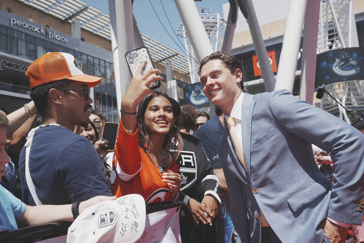 James Hagens poses for a selfie on the red carpet before the NHL hockey draft Friday, June 27, ...