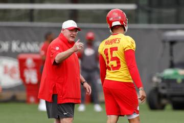 Kansas City Chiefs head coach Andy Reid, left, talks with quarterback Patrick Mahomes (15) duri ...