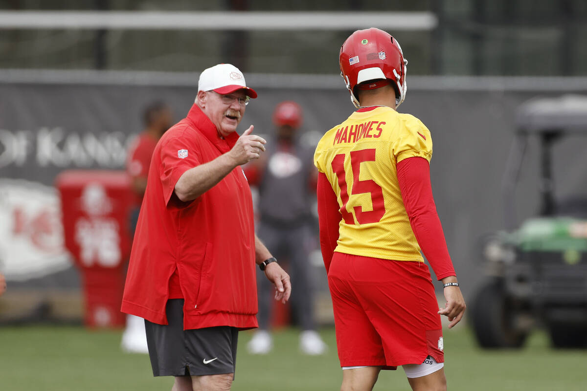 Kansas City Chiefs head coach Andy Reid, left, talks with quarterback Patrick Mahomes (15) duri ...