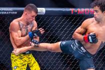 Felipe Lima takes a kick by Payton Talbott during their bantamweight fight in UFC 317 at T-Mobi ...