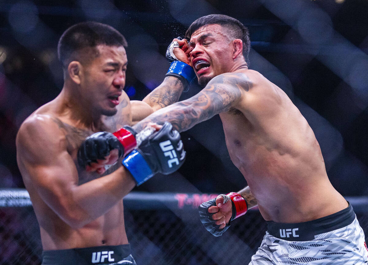 Joshua Van and Brandon Royval exchange punches during their flyweight fight in UFC 317 at T-Mob ...