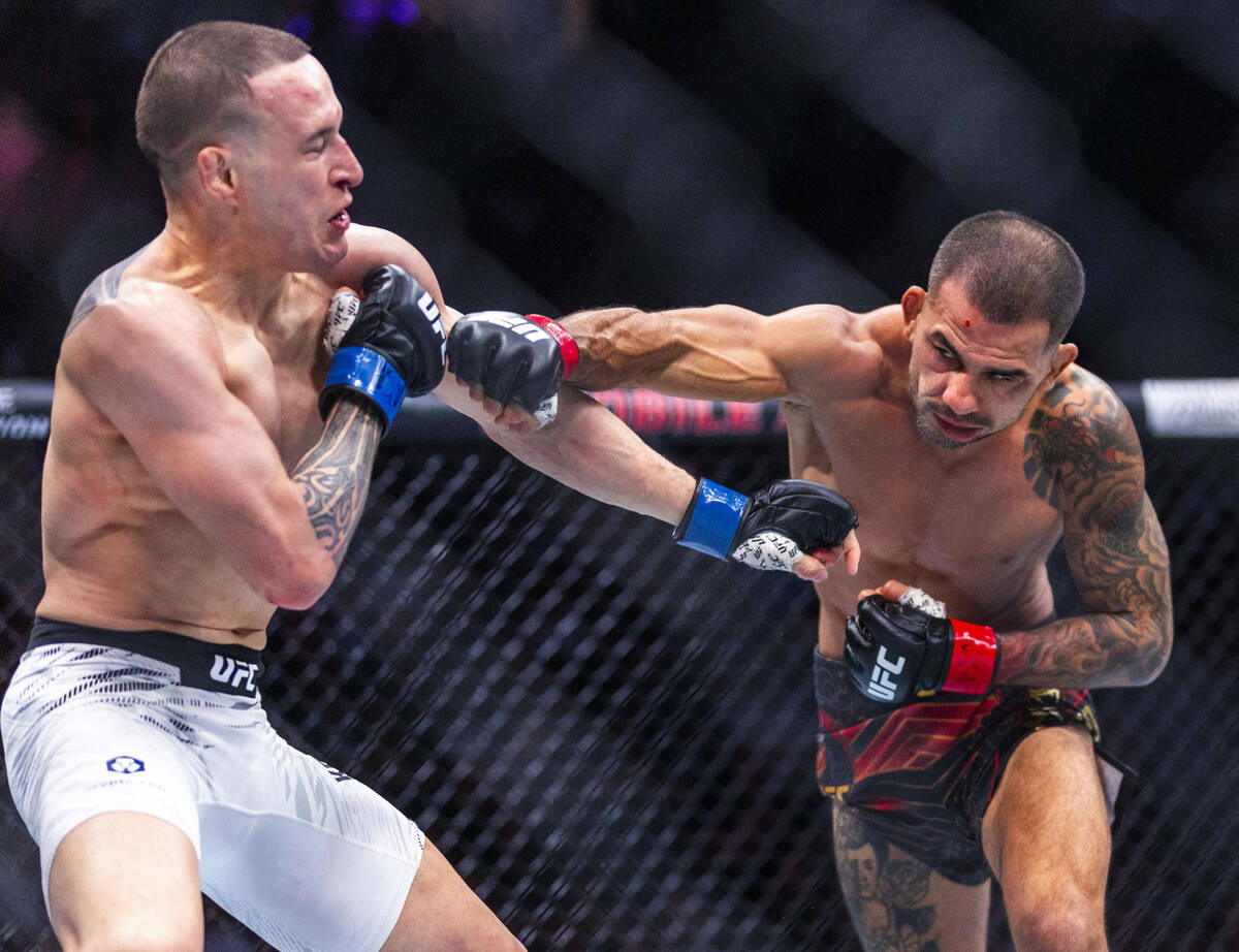 Kai Kara-France takes a strike from Alexandre Pantoja during their flyweight title fight in UFC ...