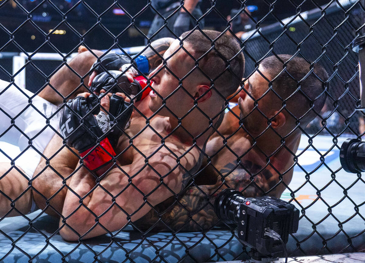Kai Kara-France is wrapped up from behind by Alexandre Pantoja during their flyweight title fig ...