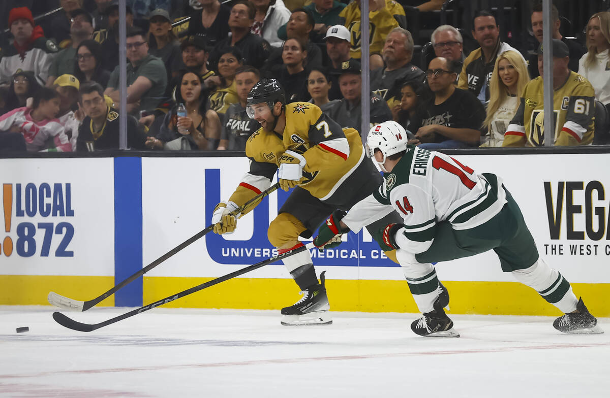 Golden Knights defenseman Alex Pietrangelo (7) moves the puck under pressure from Minnesota Wil ...