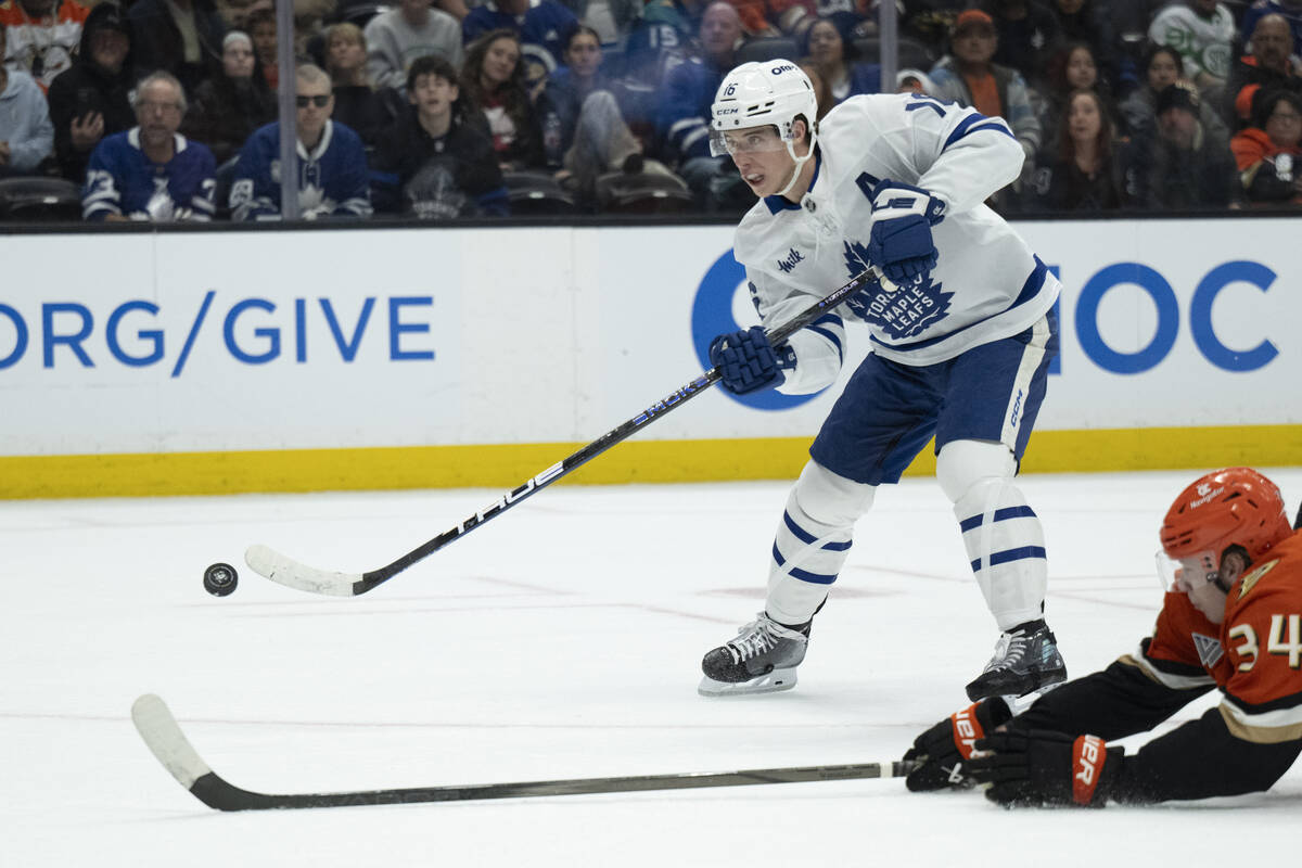 FILE - Toronto Maple Leafs right wing Mitch Marner (16) shoots past Anaheim Ducks defenseman Pa ...