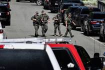 Police and fire crews respond to a shooting and fire on Canfield Mountain in Coeur d'Alene, Ida ...