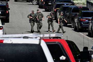 Police and fire crews respond to a shooting and fire on Canfield Mountain in Coeur d'Alene, Ida ...