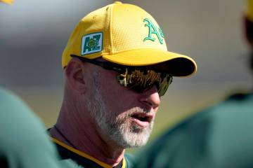 Athletics manager Mark Kotsay talks with players during a spring training baseball workout, Fri ...