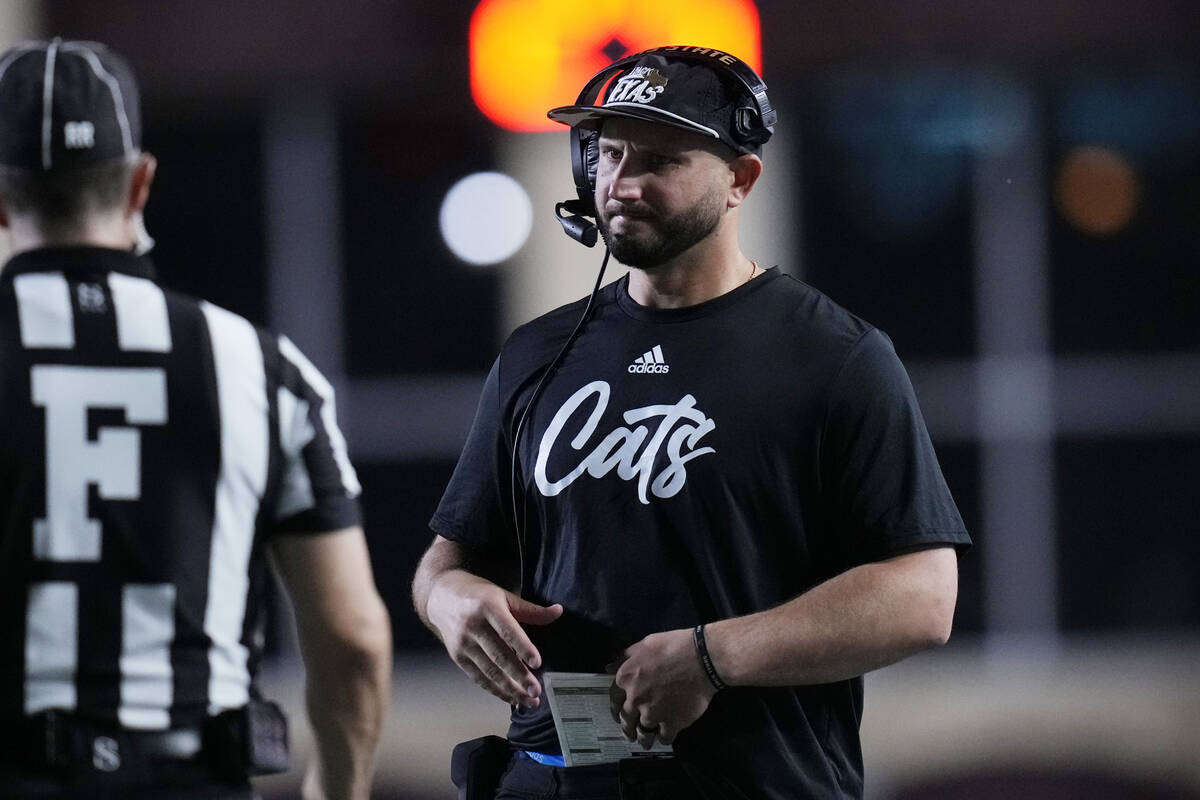 Texas State head coach GJ Kinne talks with an official during the second half of an NCAA colleg ...