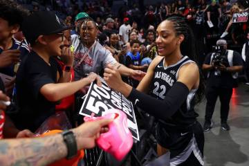 Aces center A'ja Wilson (22) signs autographs after reaching 5,000 career points in a win over ...