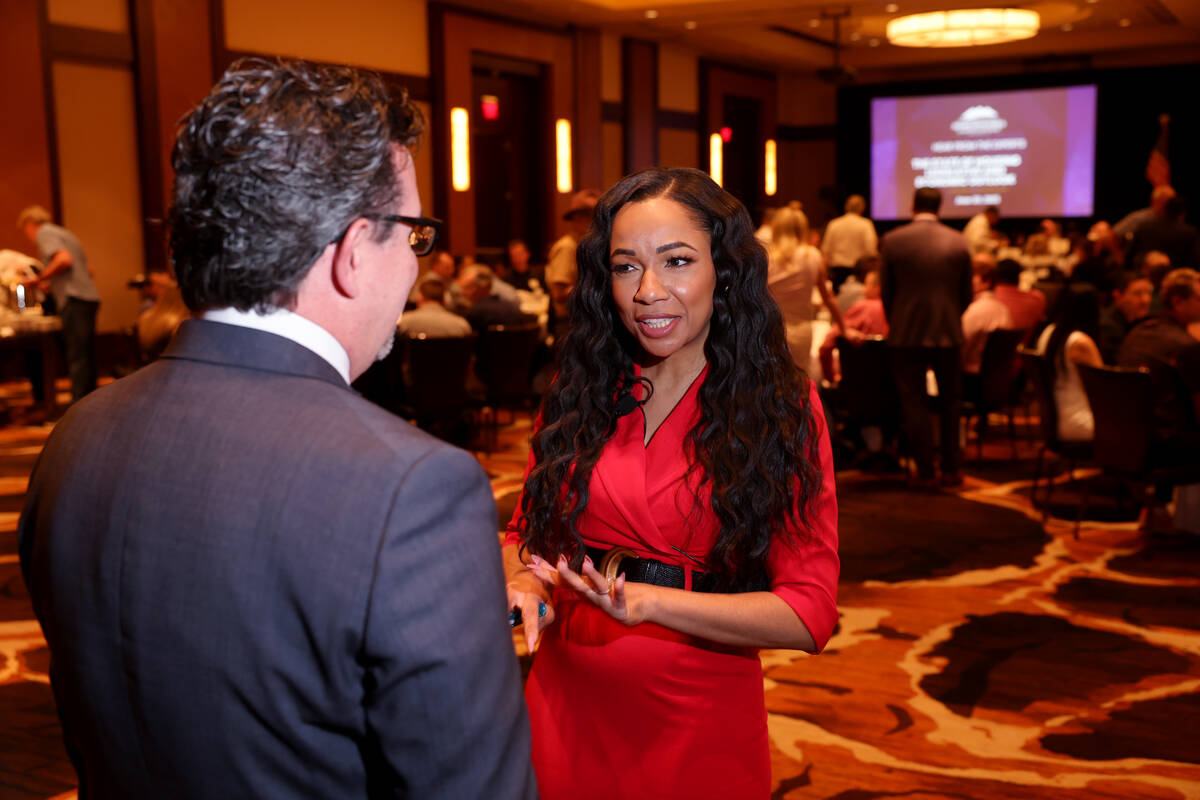 Tina Frias CEO of Southern Nevada Home Builders Association, talks to Jeremy Aguero, principal ...