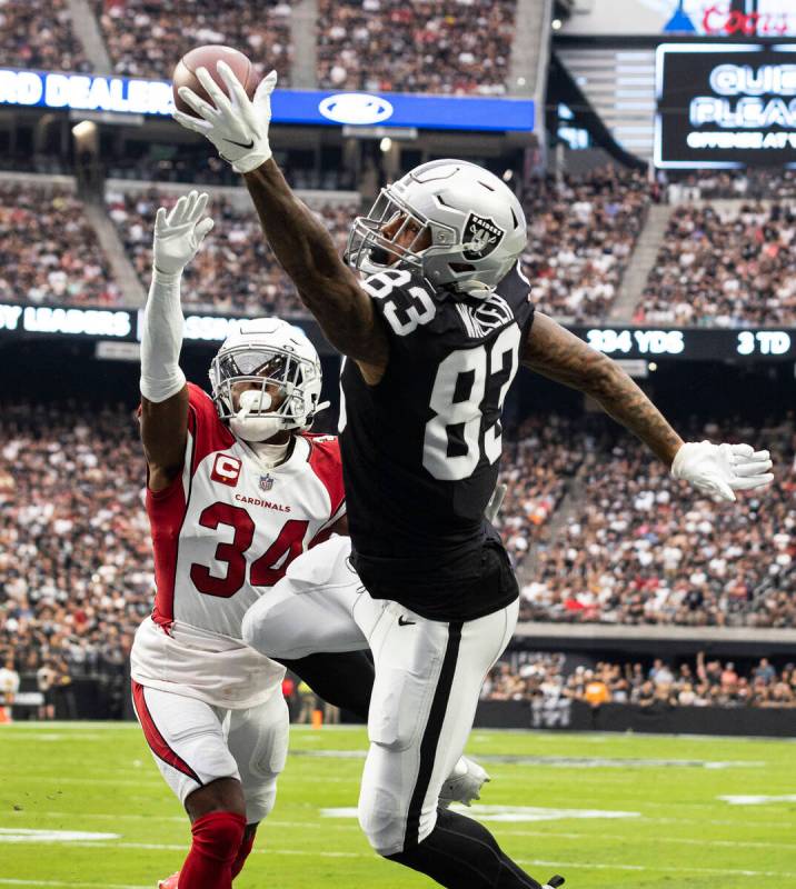 Raiders tight end Darren Waller (83) stretches to catch the ball as Arizona Cardinals safety Ja ...
