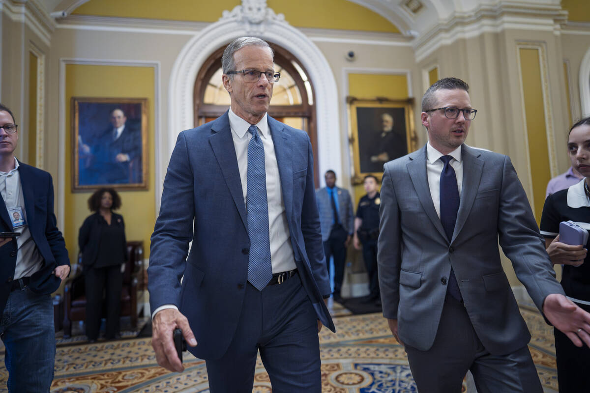 Senate Majority Leader John Thune, R-S.D., rushes from the chamber to his office as he struggle ...