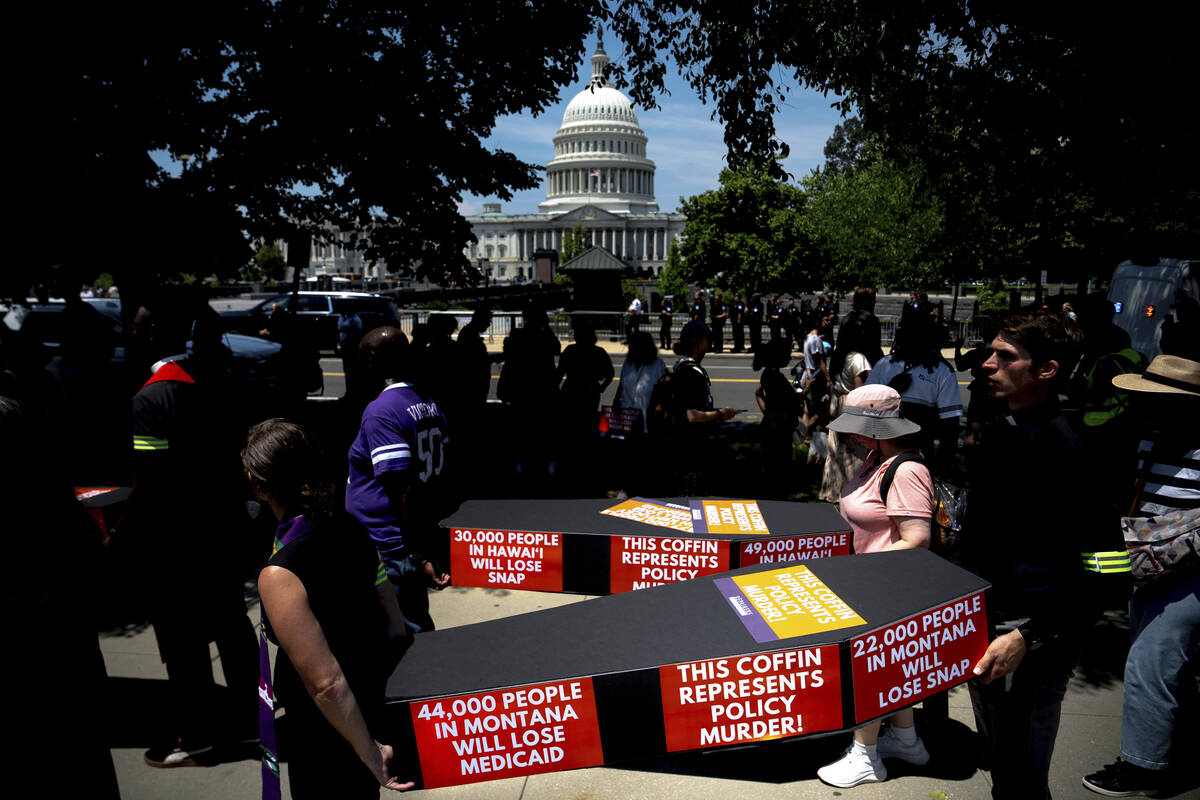 Demonstrators carry cardboard caskets in front of the U.S. Capitol in protest of President Dona ...