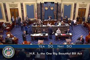 In this image from video from Senate Television, Vice President JD Vance, seated center, breaks ...