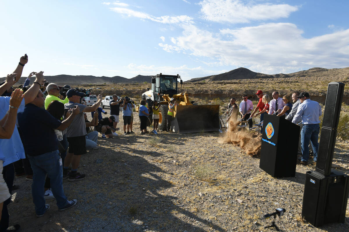 Politicians and guests take part in a ceremonial groundbreaking to mark the start of constructi ...