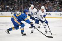 Toronto Maple Leafs' Mitch Marner (16) and St. Louis Blues' Oskar Sundqvist (70), left, reach f ...
