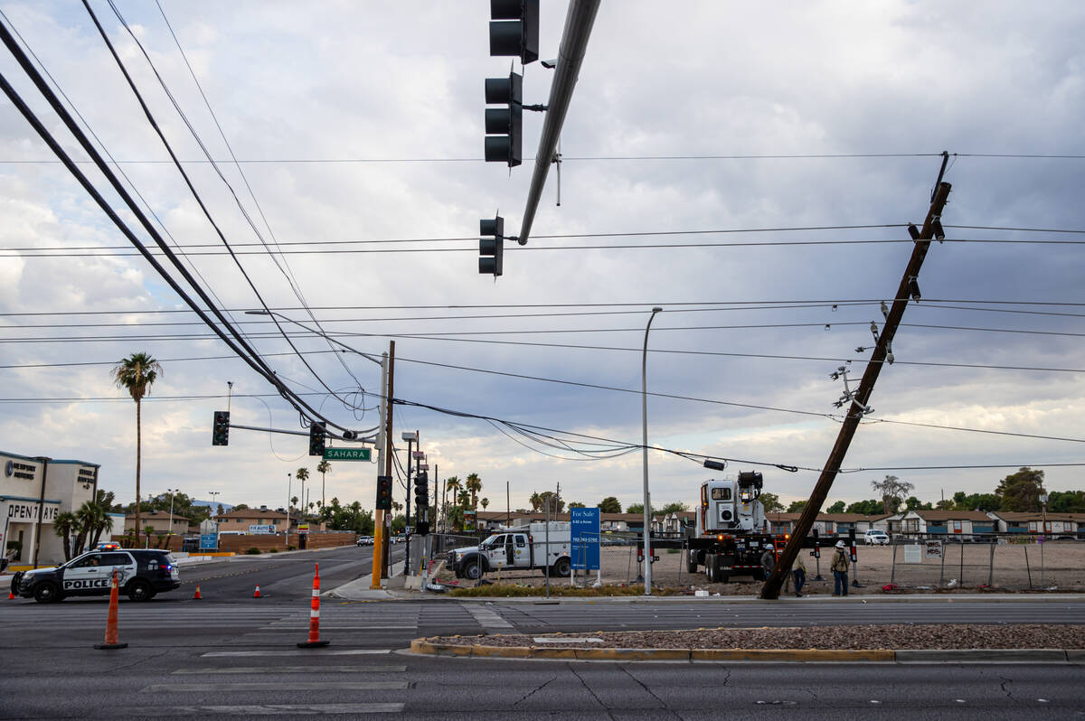 Utility crews respond to downed power lines along Sahara Avenue east of Eastern Avenue on Tuesd ...