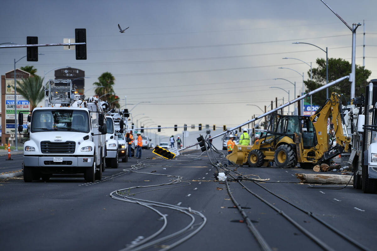 Workers remove downed power lines and lights Wednesday, July 2, 2025, on Tropicana Avenue betwe ...