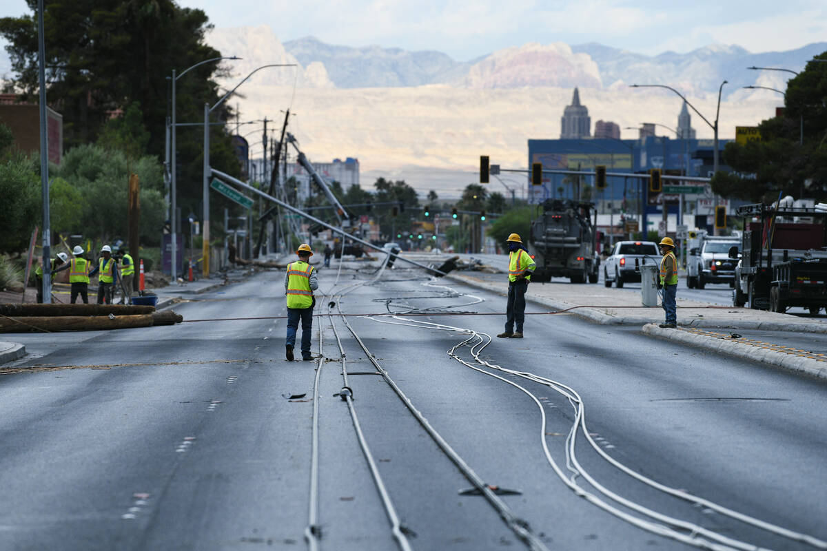 Workers clean up storm damage Wednesday, July 2, 2025, on Tropicana Avenue between McLeod Drive ...