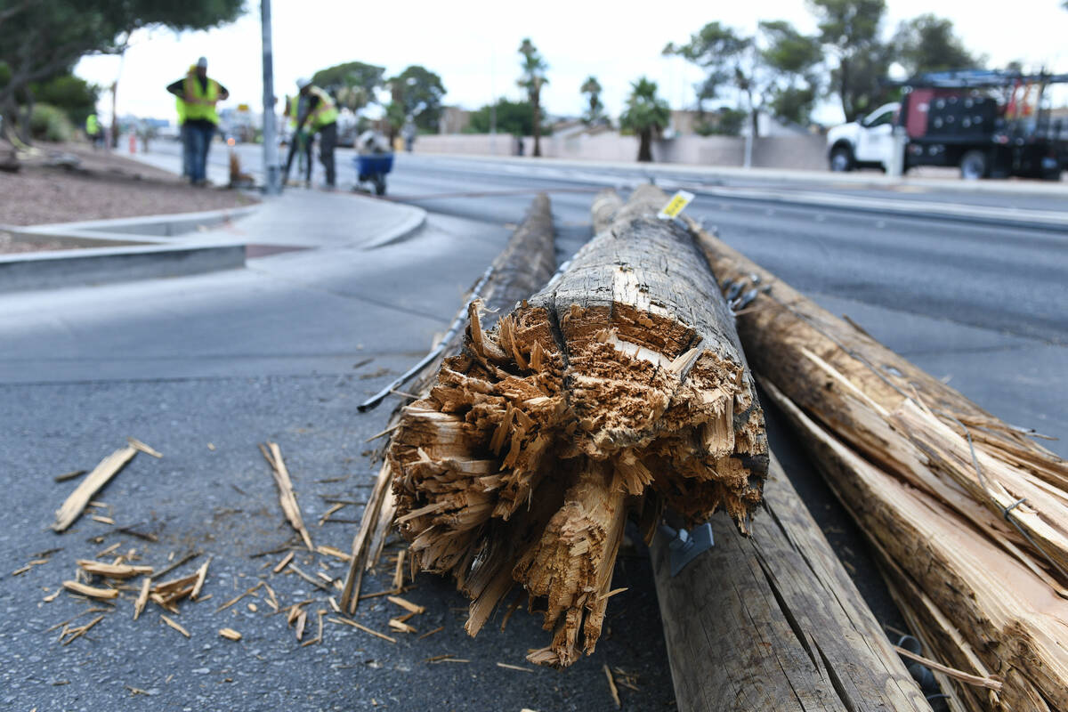 A broken power pole is seen as workers clean up storm damage Wednesday, July 2, 2025, on Tropic ...