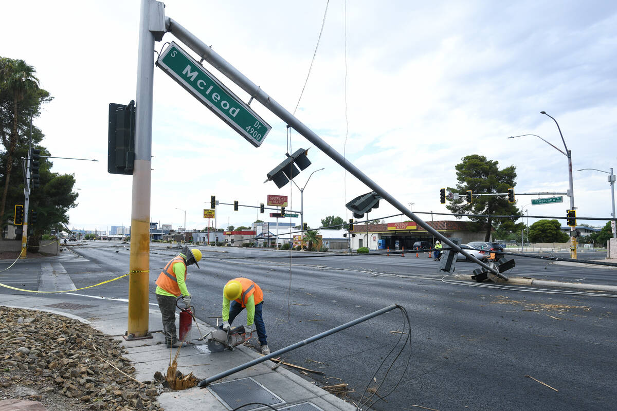 Workers clean up storm damage Wednesday, July 2, 2025, on Tropicana Avenue between McLeod Drive ...