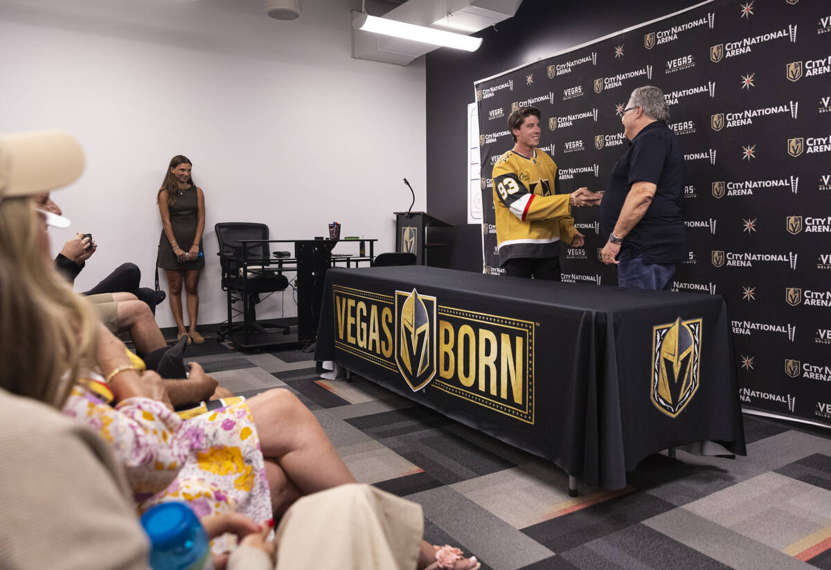 Newly acquired Golden Knights forward Mitch Marner shakes hands with Golden Knights general man ...