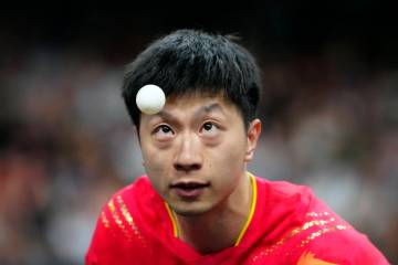 China's Ma Long, with his teammate Wang Chuqin, plays against South Korea's Cho Daeseong and Ja ...