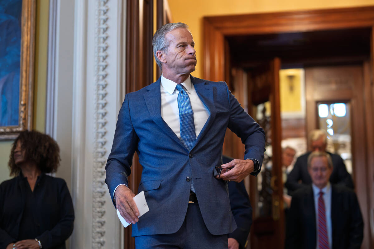 Senate Majority Leader John Thune, R-S.D., emerges from the chamber just after passage of the b ...