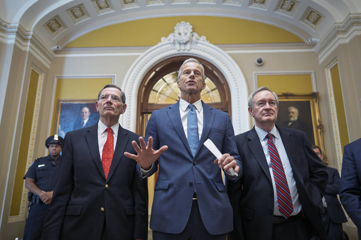 Senate Majority Leader John Thune, R-S.D., is flanked by Sen. John Barrasso, R-Wyo., the GOP wh ...