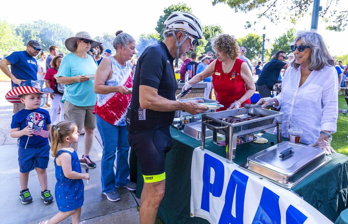 Congresswoman Dina Titus, right, serves up some sausage as part of the pancake breakfast served ...