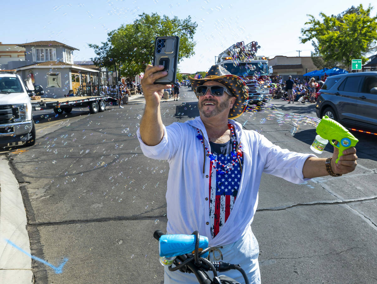 Jimmy "Vegas" Sammarco shoots off a bunch of bubbles as the parade begins to travels ...
