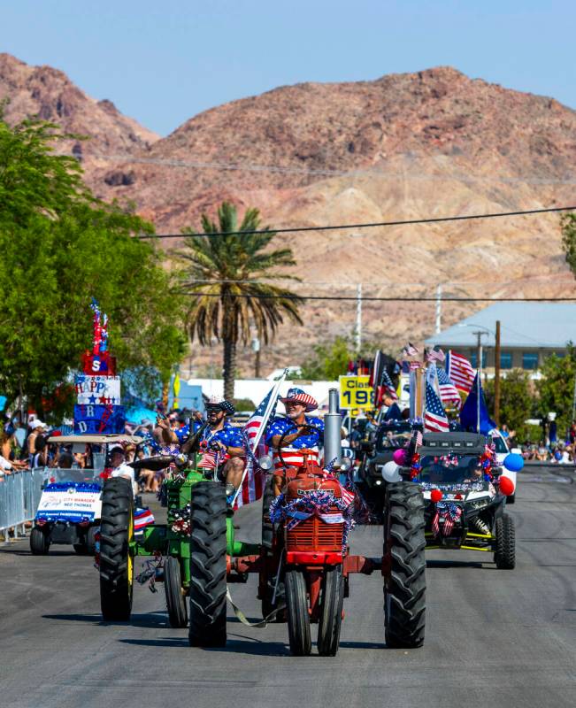 Tractors decked out with decorations and an eagle move down Fifth Street during the parade at t ...
