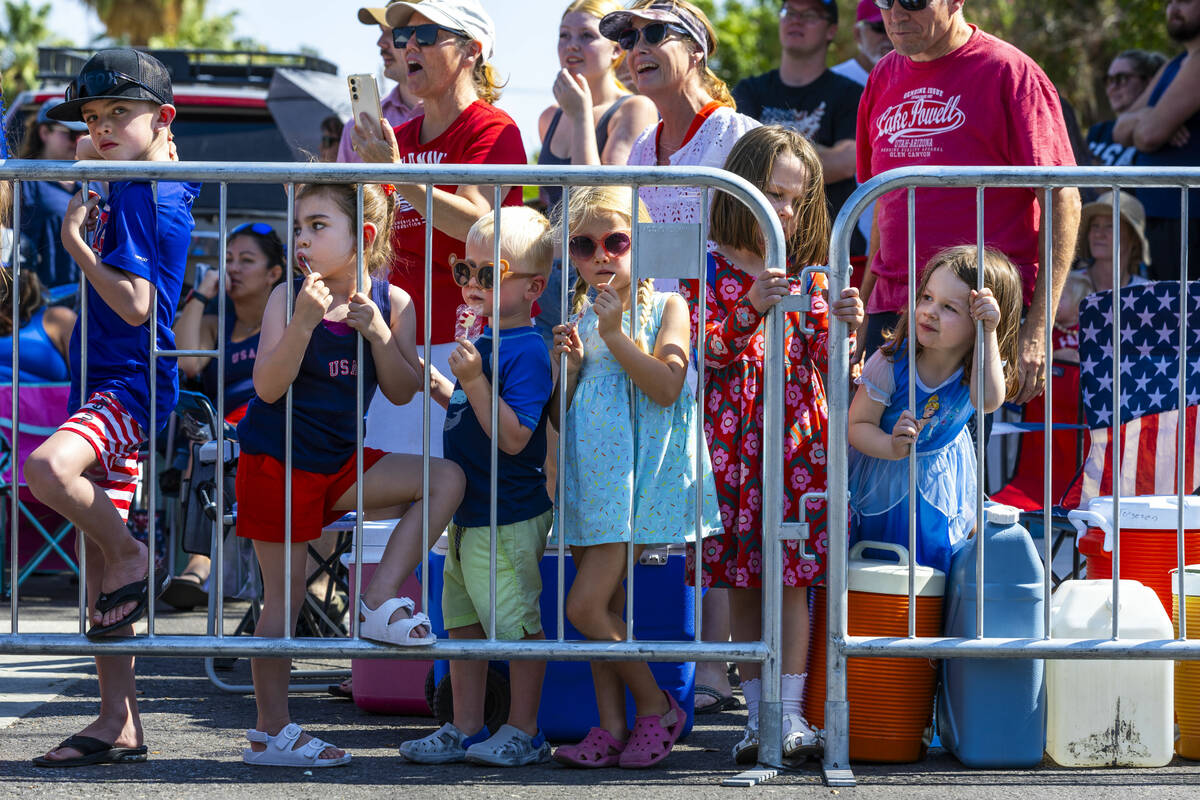 Young attendees line about behind the barricades looking to catch a glimpse of the floats durin ...