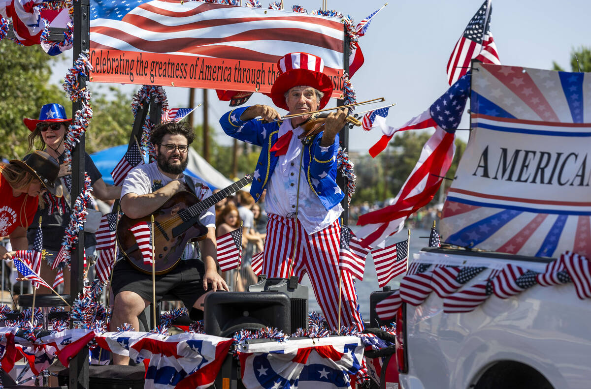 The Americana Man plays for the crowd as his float moves along the route during the 77th Annual ...