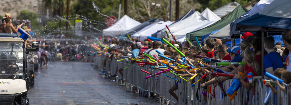 Blasts of water erupt as the floats navigate through the "wet area" section of the parade durin ...