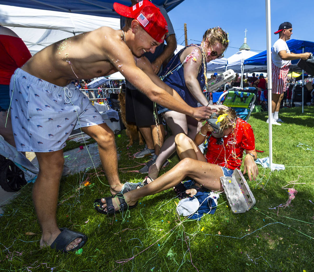 Heather Nelson, below, is attacked with confetti eggs after a silly string fight during the 77t ...