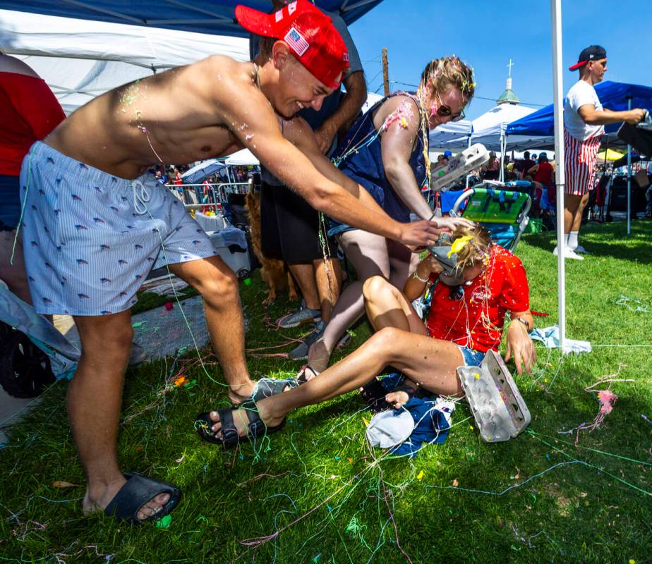 Heather Nelson, below, is attacked with confetti eggs after a silly string fight during the 77t ...