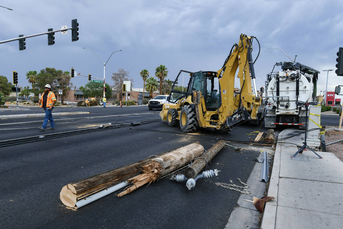 Workers clean up storm damage Wednesday, July 2, 2025, on Tropicana Avenue between McLeod Drive ...