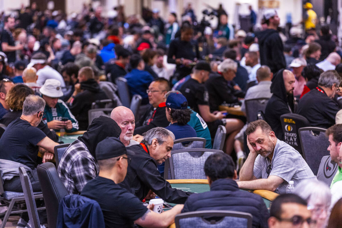 Players work to build their chip counts as play continues during the opening day of the WSOP Ma ...