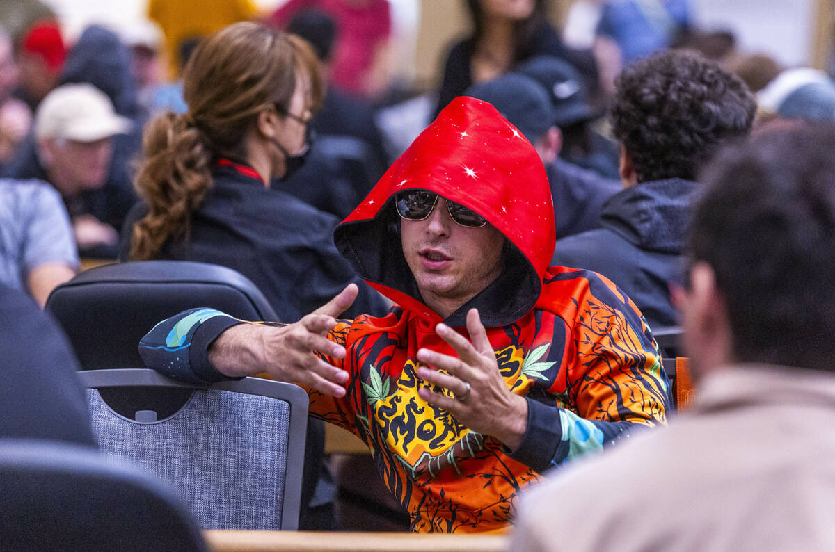 A player chats with others at his table during opening day of the WSOP Main Event at the Horses ...