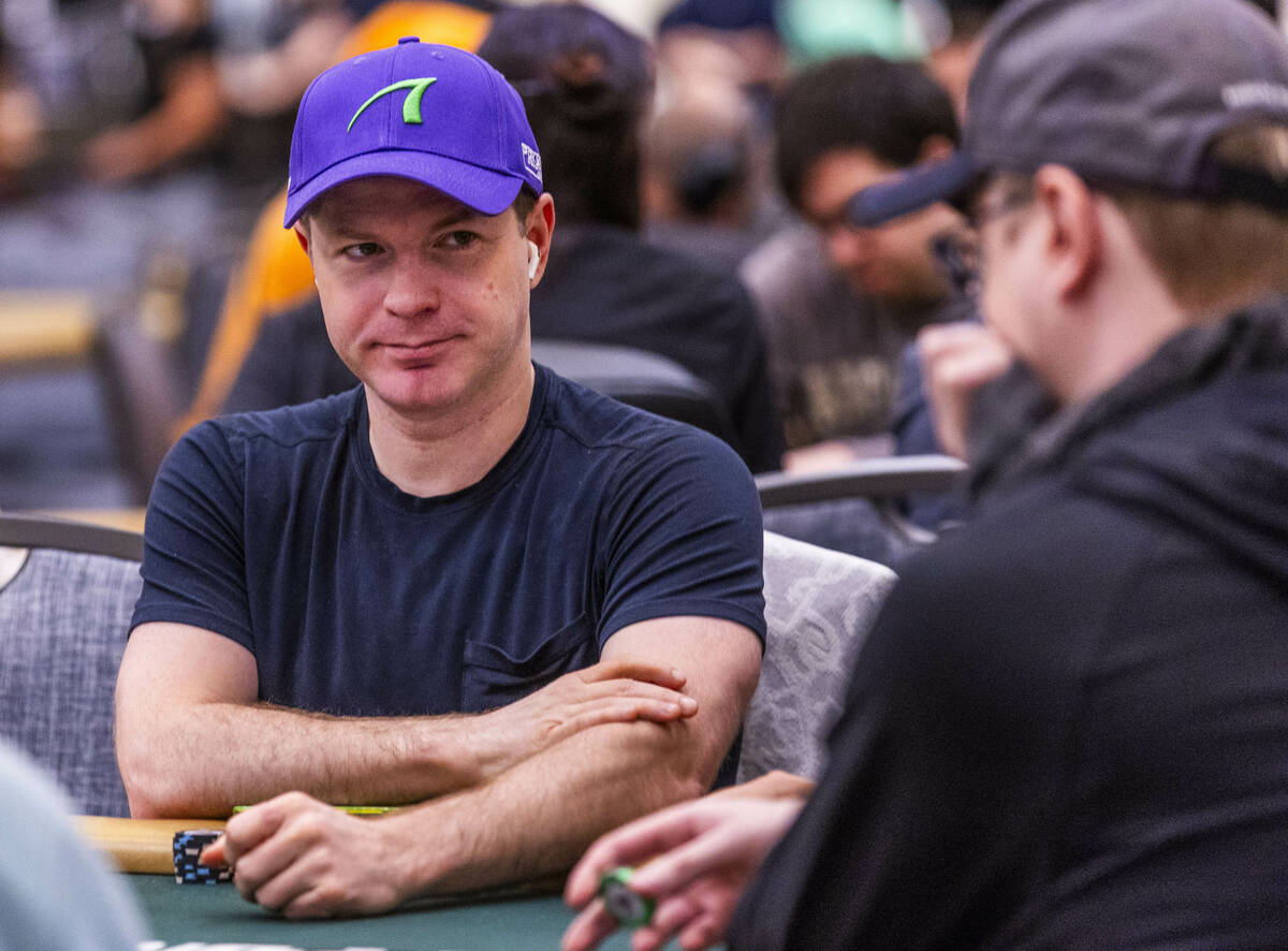 Professional poker player Jonathan Little watches the competitors at his table during opening d ...