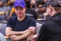 Professional poker player Jonathan Little watches the competitors at his table during opening d ...