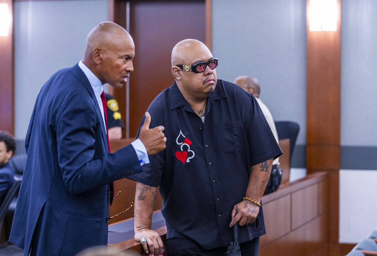 Defense attorney Carl Arnold talks with an observer at the rail as the evidentiary hearing cont ...