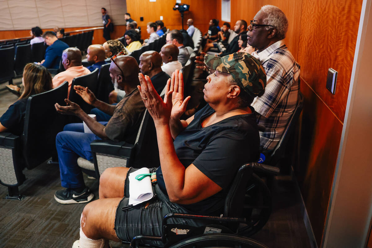 Pamela Neal, a Windsor Park resident, claps during a city council meeting and agenda item conce ...