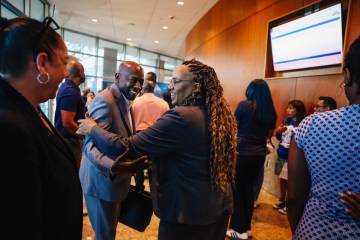 Architect Winston Henderson, left, greets Nevada state senator Dina Neal after a city council m ...