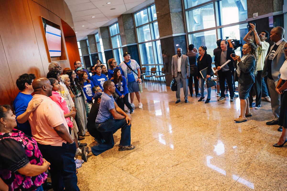 A group poses for a picture during a city council meeting and agenda item concerning a new Wind ...