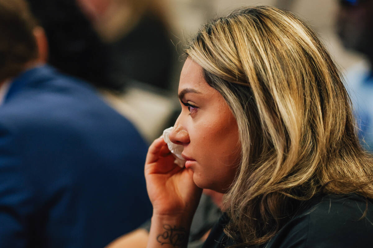 A community member wipes away a tear during a city council meeting and agenda item concerning a ...