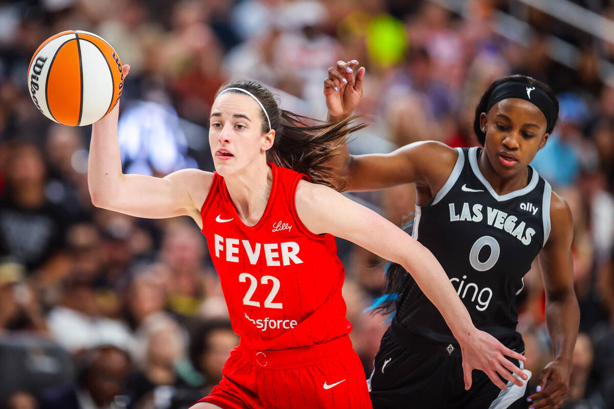 Indiana Fever guard Caitlin Clark (22) dribbles the ball as Aces guard Jackie Young (0) defends ...