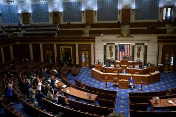 House Minority Leader Hakeem Jeffries, D-N.Y., left, speaks in the House chamber as House Democ ...